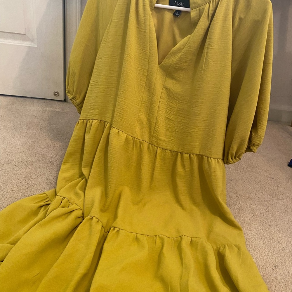 Mustard colored knee length dress with with ruffled bottom